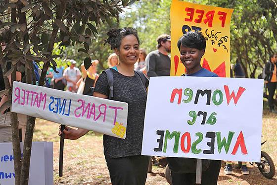 两名妇女举着抗议标语，上面写着“变性人的生命很重要”和“女人很了不起”